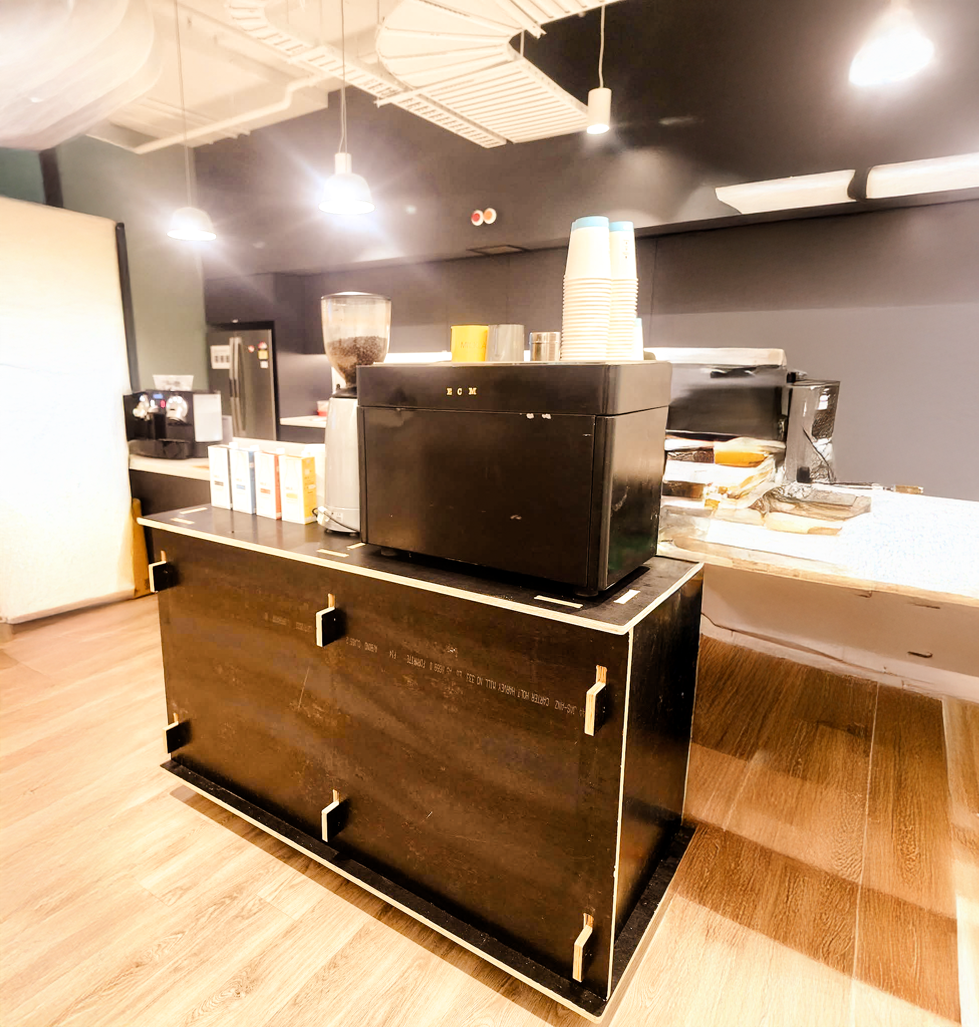 The Kart — sleek black indoor coffee kart with espresso machine on top