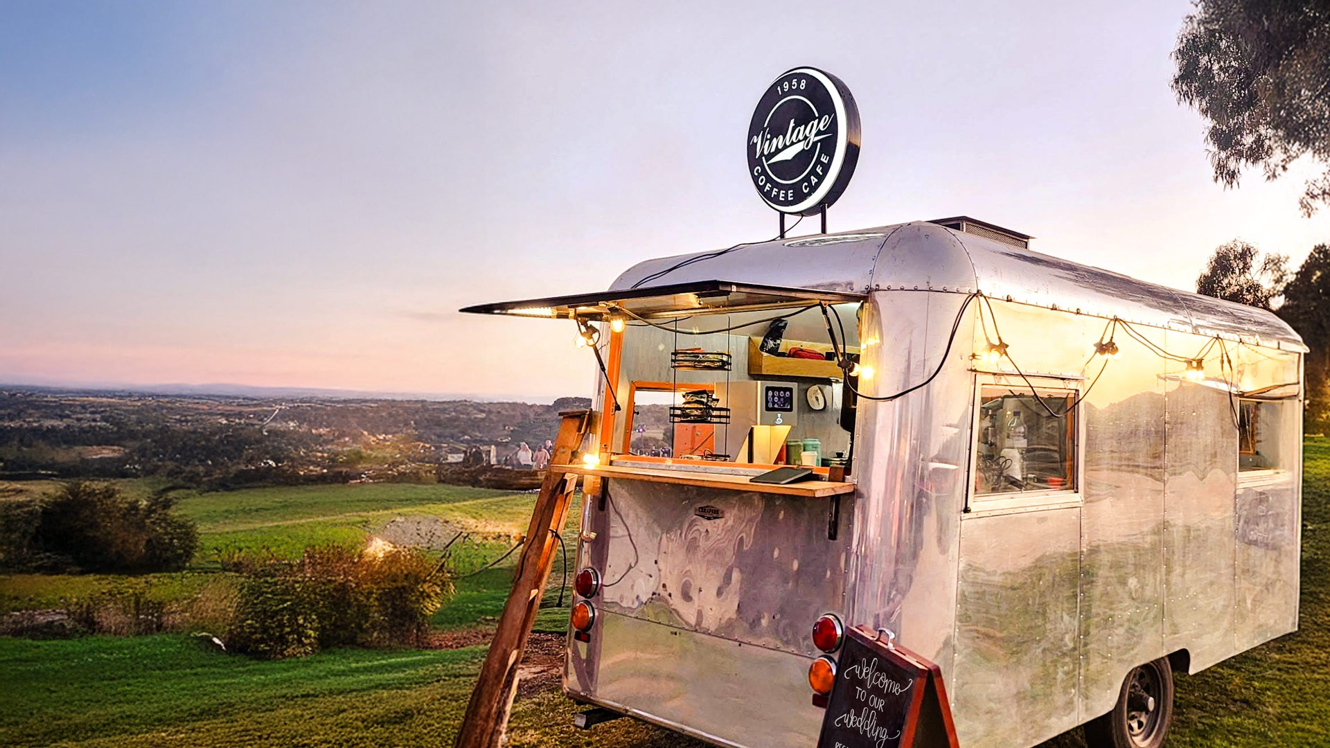 Vintage silver Carapark coffee trailer at sunset overlooking rolling hills