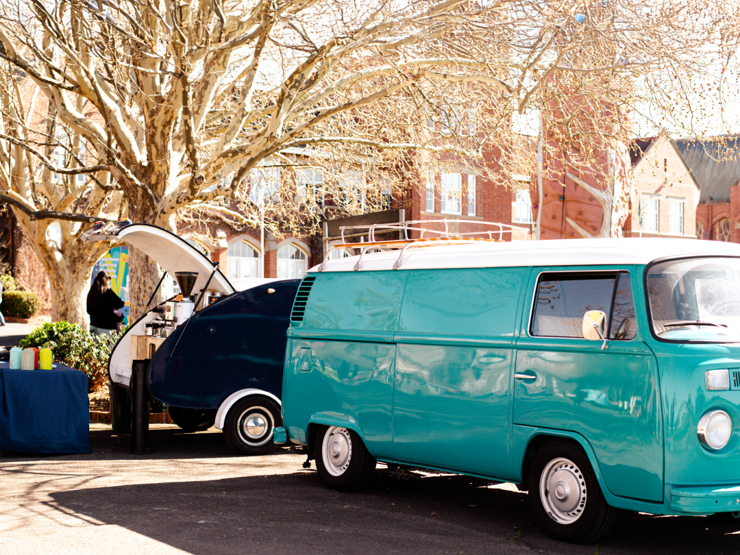 The Kombi & The Drop — a turquoise 1973 Kombi towing an art-deco teardrop trailer